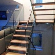 double flight staircase with open risers and glass balustrade