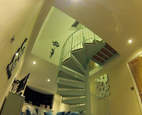 steel spiral staircase in a living room with carpeted floor