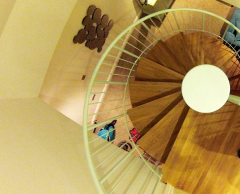oak treads on a spiral staircase with a white centre column