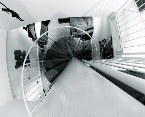 black and white picture looking down a spiral staircase