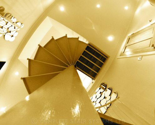 centre column of a white spiral staircase looking up