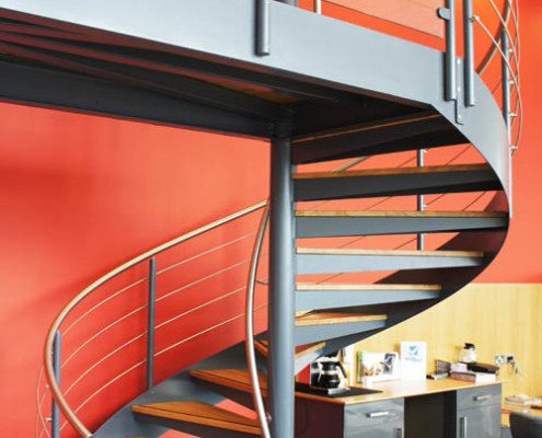 dark grey spiral staircase with balcony with glass