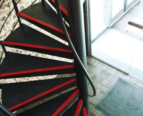 black spiral staircase with red strips