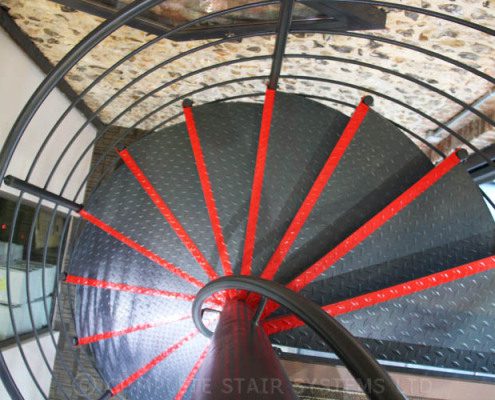 red strips to front of black steel staircase steps