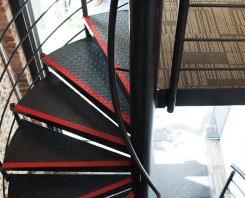 black steel centre column on a spiral stair with tear plate treads