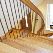 looking down on an oak tread stair with stainless spindles