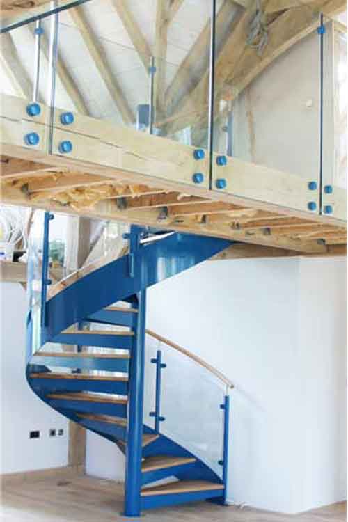 blue spiral stair leading up to a walkway with frameless glass