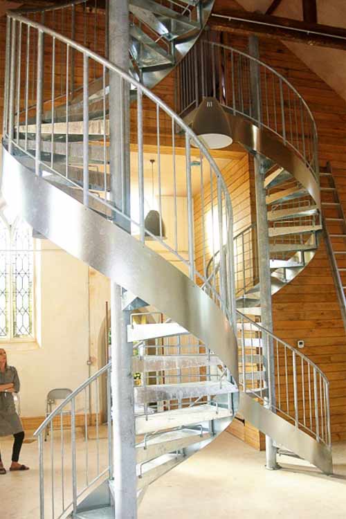2 internal galvanised spiral stairs in a timber framed building
