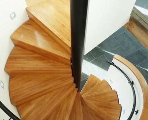 oak tread spiral staircase with black steel centre column and handrail