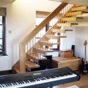 keyboard in front of a floating style oak staircase with stainless spindles