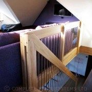purple sofa behind some landing balustrade above a floating oak stair
