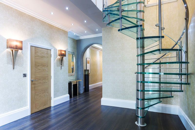 large hallway with glass step spiral stair