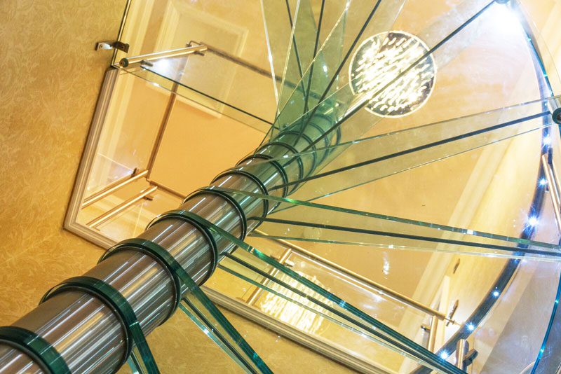 LED light in handrail of a glass step spiral staircase