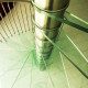 close up on glass step spiral staircase and stainless steel spindles