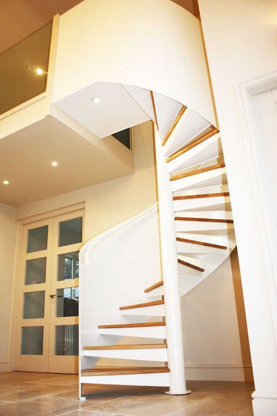 curved steel balustrade around a white spiral staircase