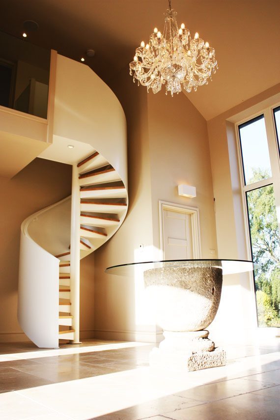 curved solid balustrade around a spiral staircase in white