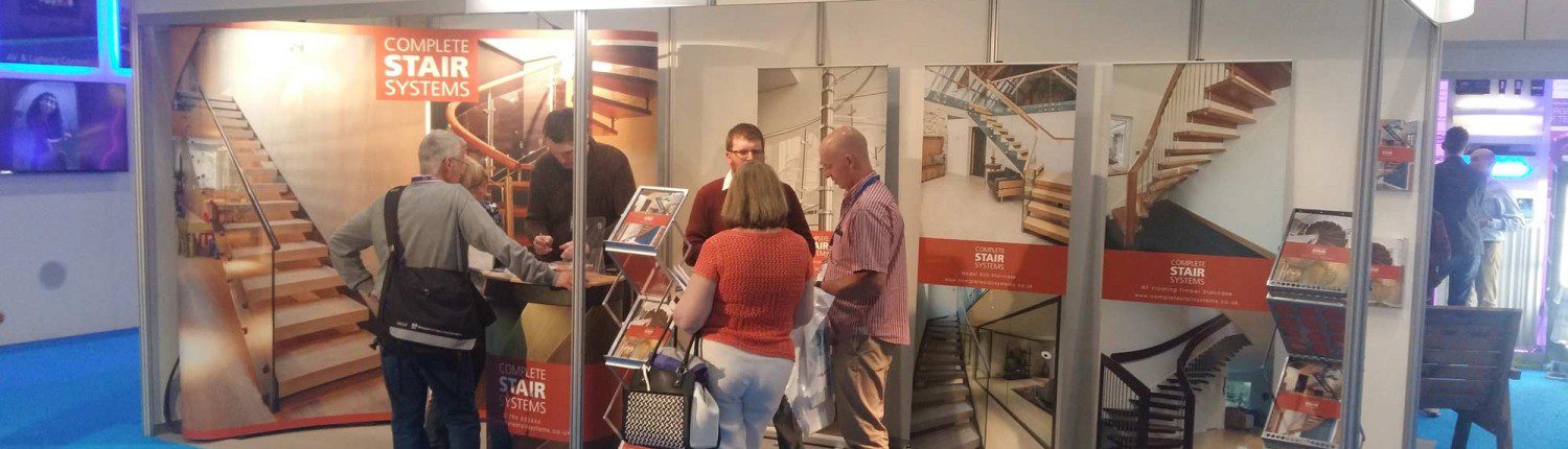 exhibition stand with stair pictures and blue carpet