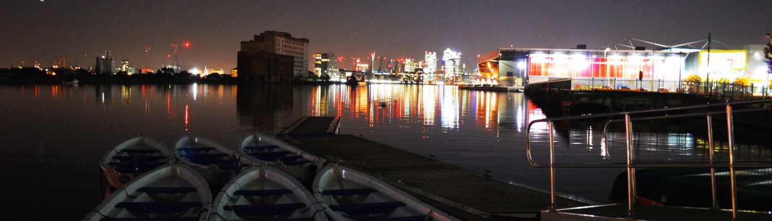 Thames at night with excel centre lit up
