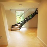 hallway with large black and glass staircase