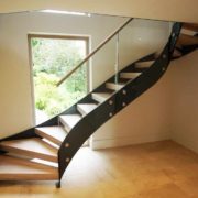 black steel stair in front of window in house with timber steps