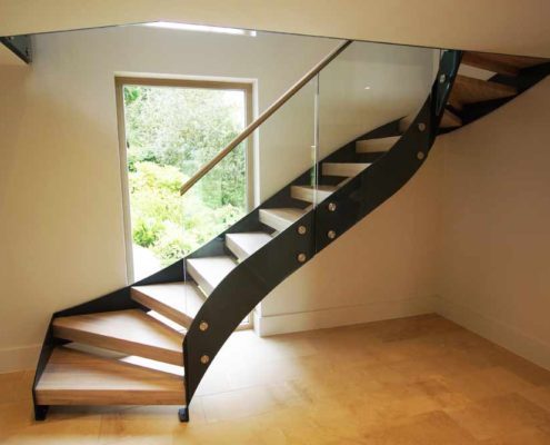 Bespoke-Staircase-Alresford-2 black steel stair in front of window in house with timber steps