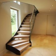 open riser staircase in front of window in hallway