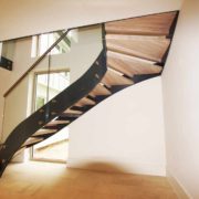 black steel staircase with frameless glass balustrade