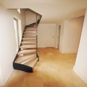 Open riser staircase with wooden steps and black steel stringers