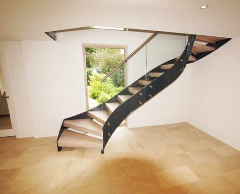 Bespoke-Staircase-Alresford-7 black steel staircase with timber steps in front of a window