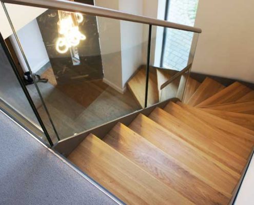 Bespoke-Staircase-Croxley-Green-1 oak steps on a modern glass and steel stair