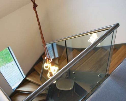 Bespoke-Staircase-Croxley-Green-2 glass landing balustrade at the top of a model steel and wood staircase