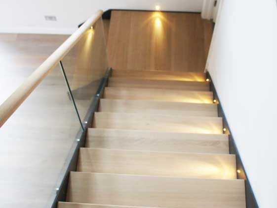 Bespoke-Staircase-Godalming-1 oak steps on a steel and glass stair with platform