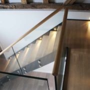oak platform above a staircase with glass balustrade