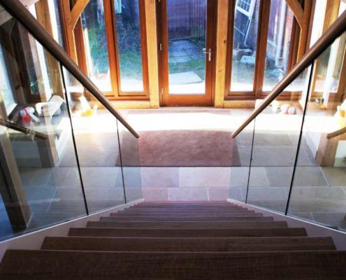 Bespoke-Staircase-Whitchurch-1 oak steps on a steel and glass staircase in a large hallway