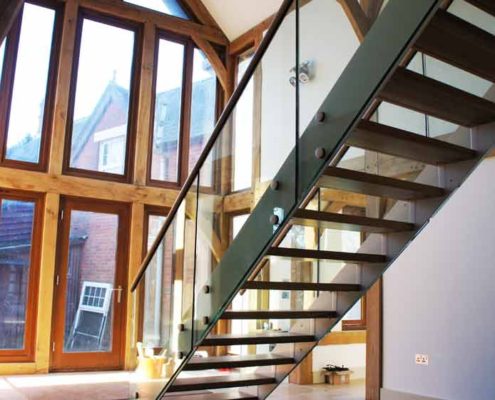 Bespoke-Staircase-Whitchurch-5 white steel staircase in front of large wood framed window