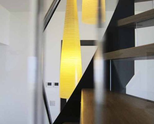 Modern-Stair-Berwick-Upon-Tweed-1 yellow cone light behind a black steel staircase