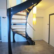 freestanding black open riser stair with yellow lights