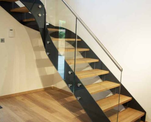 Modern-Staircase-Bromley-3 quarter turn black steel stair running up against wall with glass panels