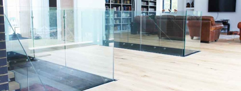 Modern-Staircase-Stamford-4 living area with two stairwells surrounded with glass panels