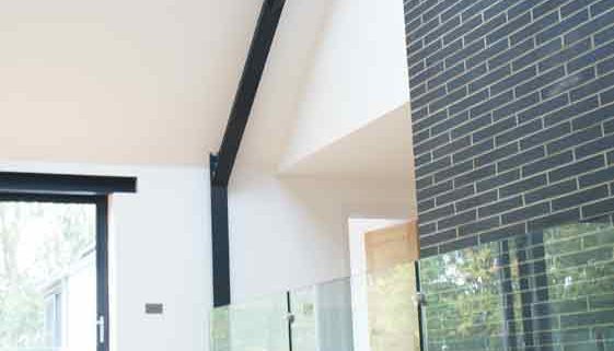 Modern-Staircase-Stamford-7 circular ceiling feature above a timber floor and landing balustrade with frameless glass