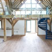 mezzanine level with frameless glass balustrade and blue spiral stair
