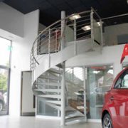 spiral stair in a car showroom in white steel