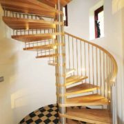 large oak and stainless steel spindles with curved wall behind