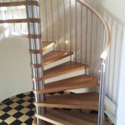 spiral stair on a checked floor set within curved wall