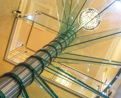 the underside of glass steps on a spiral staircase