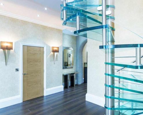 laminated glass steps on a spiral stair in a hallway