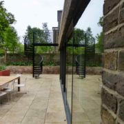 outdoor black spiral staircase alongside a window