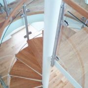 white centre column in middle of an oak step spiral staircase