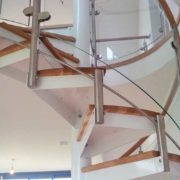 curved glass panels around the side of a spiral staircase