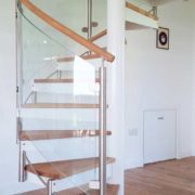 timber floored room with white and oak spiral staircase on top